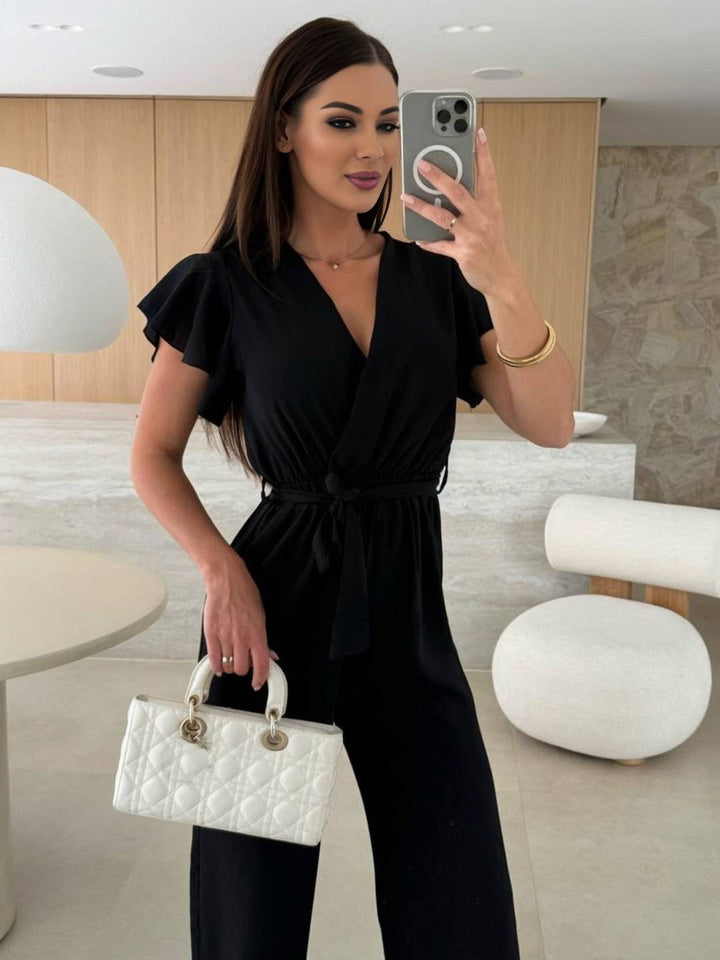 Kombinezon damski Rochelle - Elegancki gładki kombinezon z dekoltem w szpic, paskiem i falbanami na nogawkach
