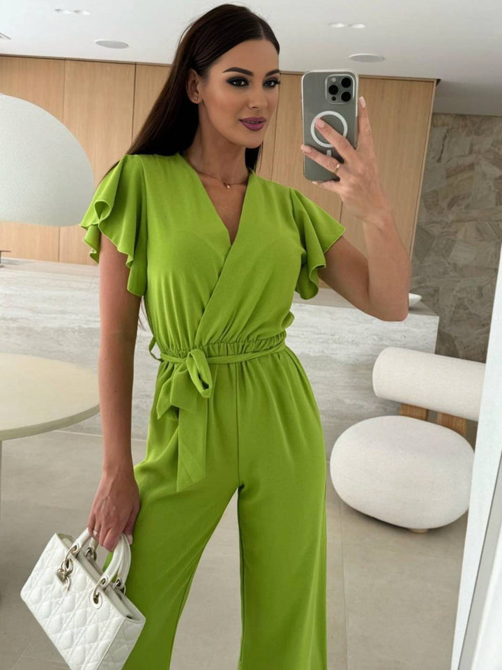 Kombinezon damski Rochelle - Elegancki gładki kombinezon z dekoltem w szpic, paskiem i falbanami na nogawkach