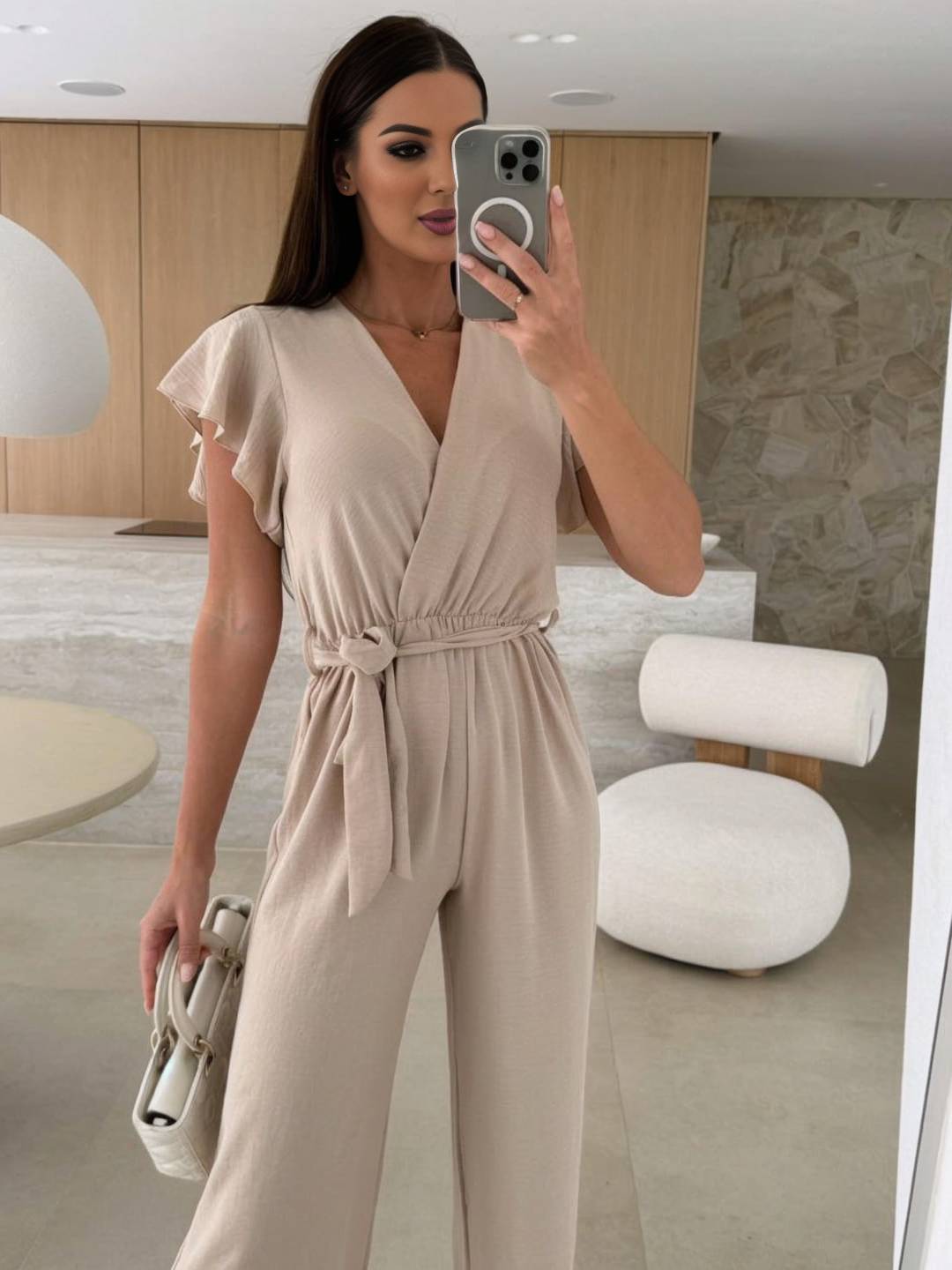 Kombinezon damski Rochelle - Elegancki gładki kombinezon z dekoltem w szpic, paskiem i falbanami na nogawkach